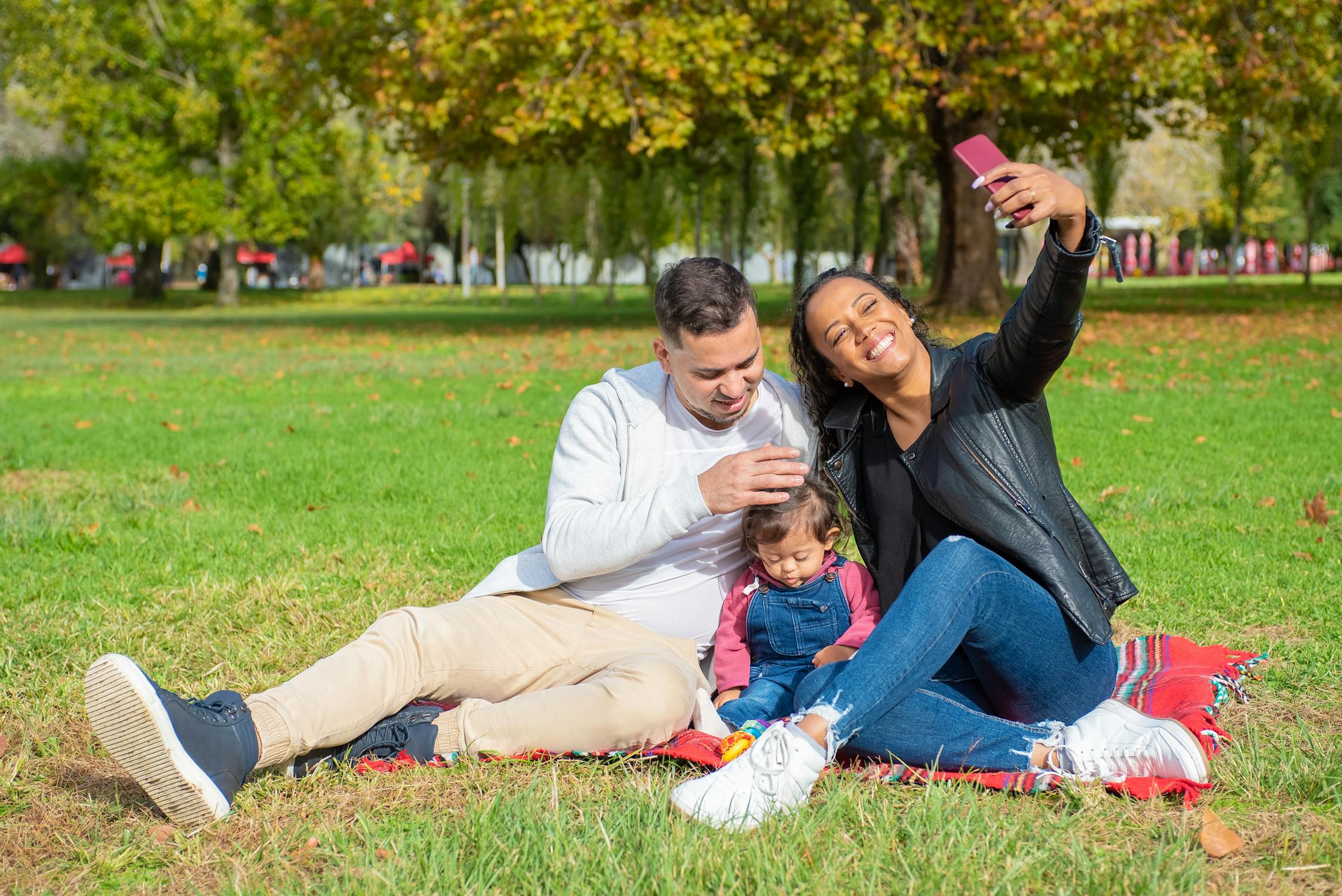 Family with child taking a selfie and enjoying spring in a park in Livermore, CA.